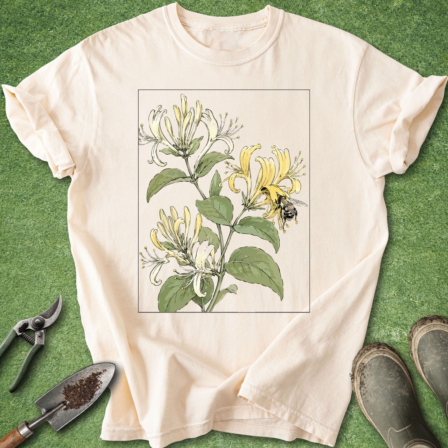 Ivory t-shirt featuring a vintage botanical illustration of blooming honeysuckle flowers with a bumblebee collecting nectar.