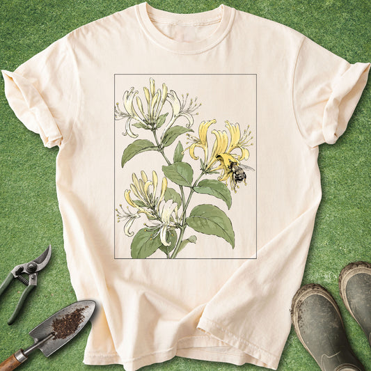 Ivory t-shirt featuring a vintage botanical illustration of blooming honeysuckle flowers with a bumblebee collecting nectar.