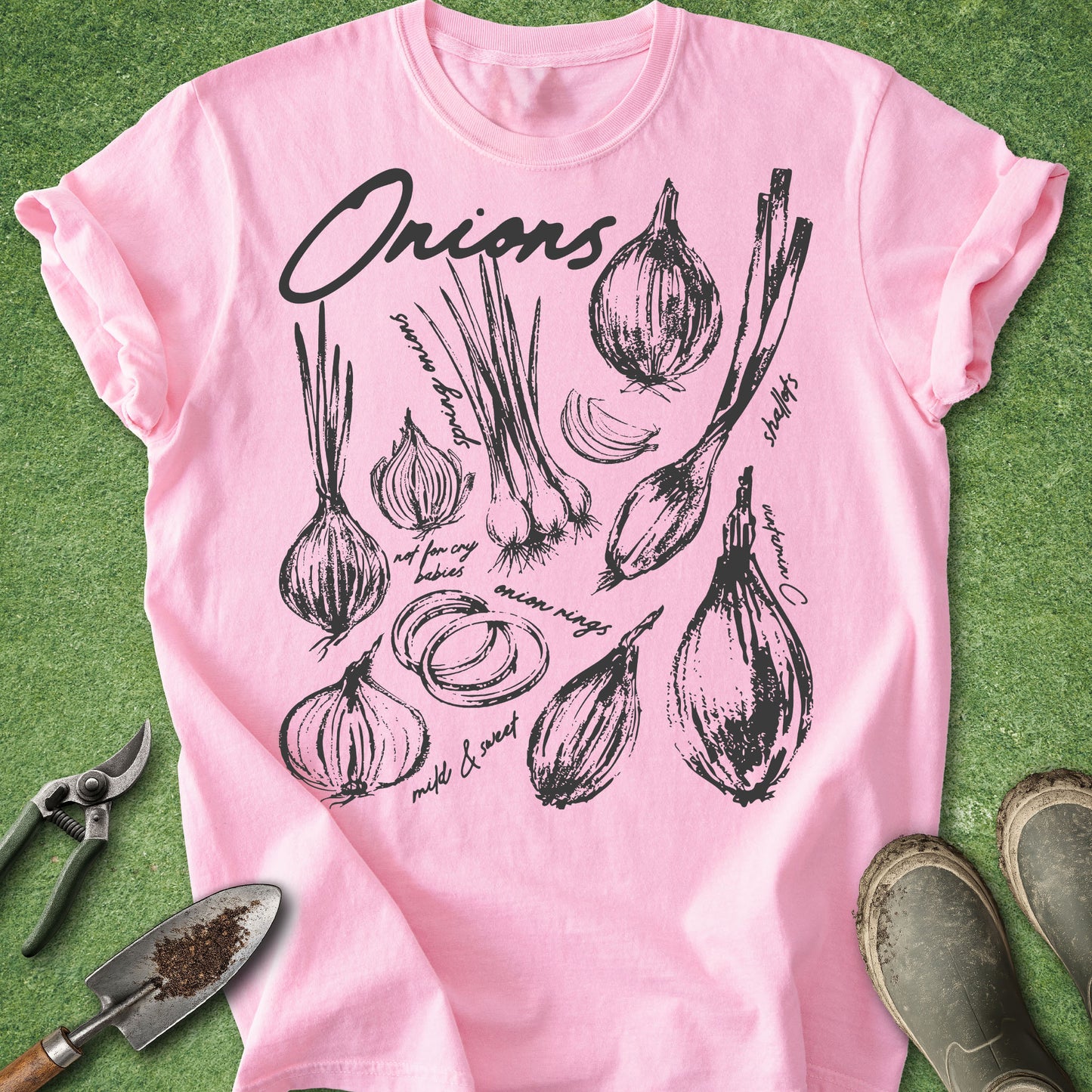 Pink t-shirt with black onion illustrations on a green background