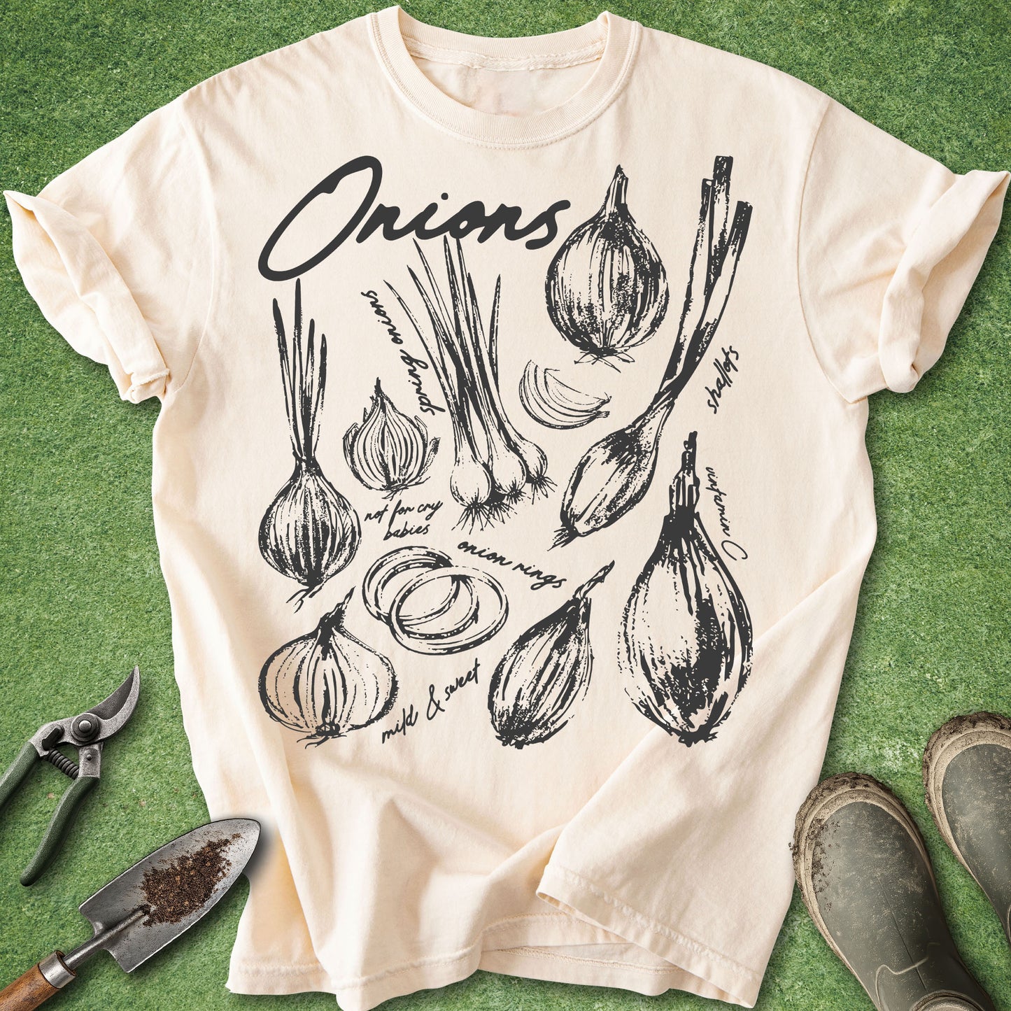 Ivory Comfort Colors t-shirt featuring vintage botanical illustrations of onions, scallions, onion slices, and onion rings arranged in a hand-drawn garden study design.