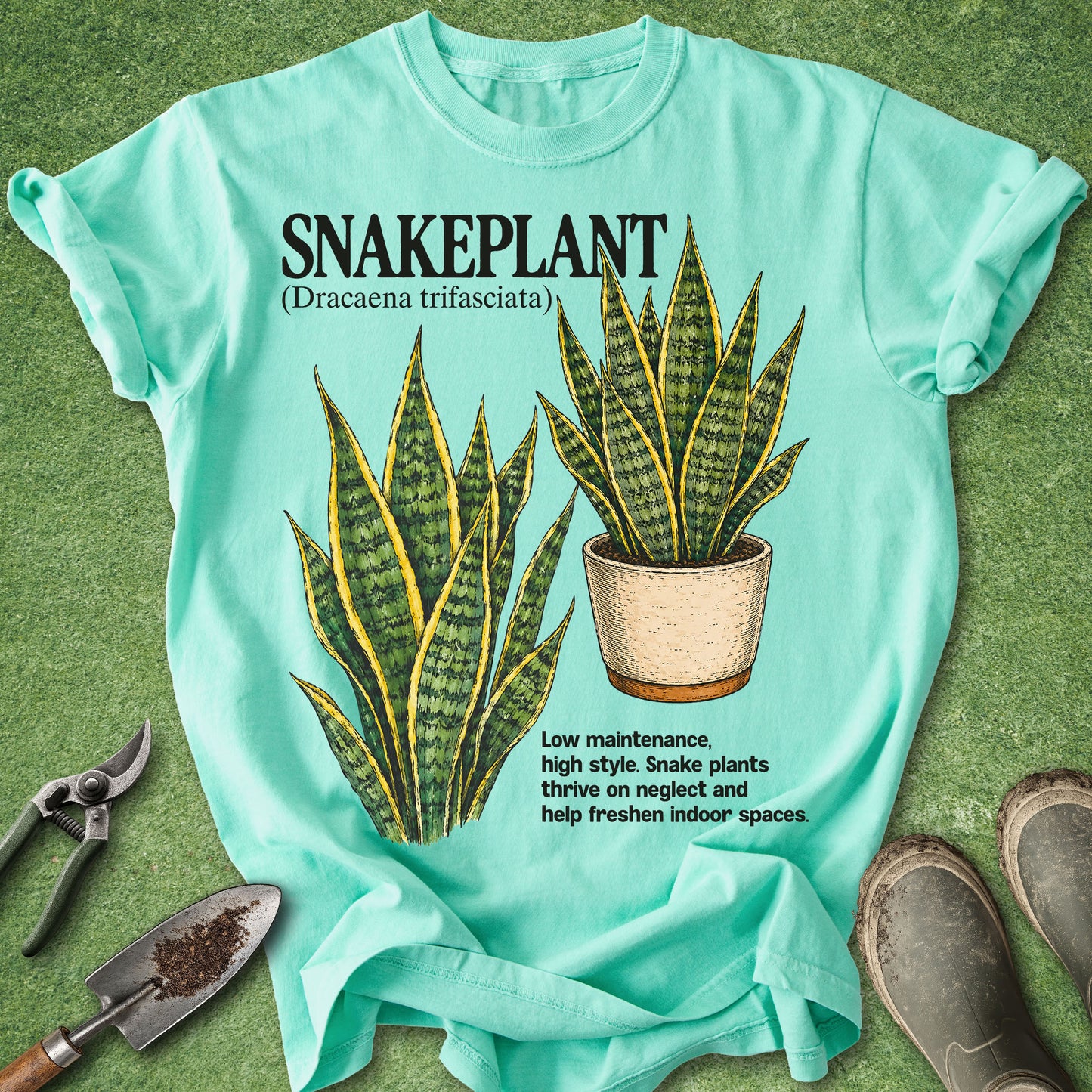 Light blue t-shirt with snake plant graphic and text on a green background