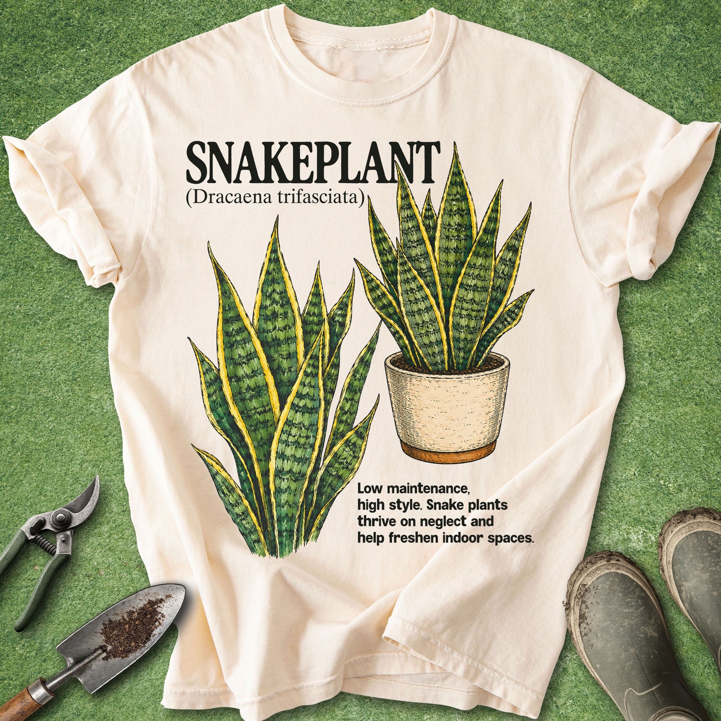 White t-shirt with snake plant graphic and text on a green background