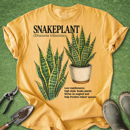 Mustard Comfort Colors t-shirt featuring botanical illustrations of Snake Plants (Dracaena trifasciata) with detailed green leaves and a potted plant design, perfect for houseplant lovers and plant parents.