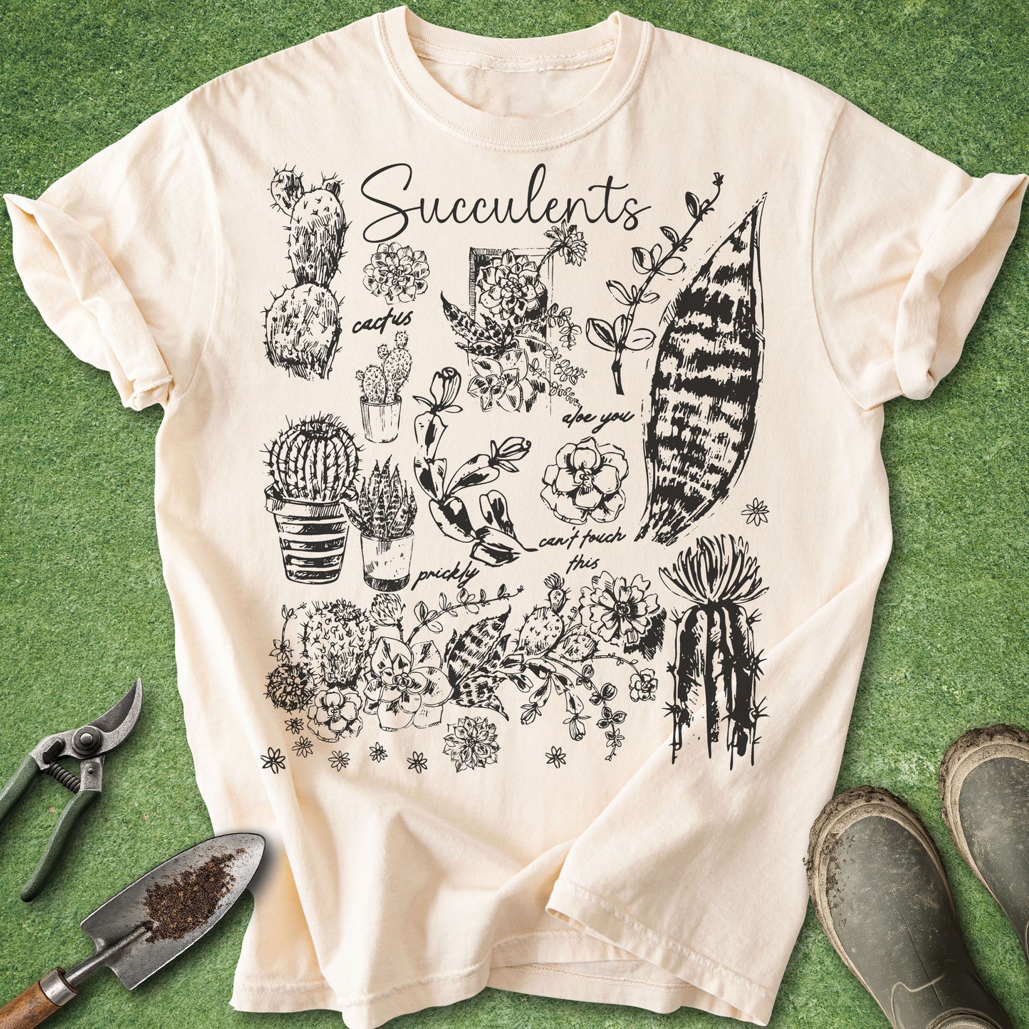Ivory Comfort Colors t-shirt featuring a vintage botanical collage of succulents, cacti, snake plants, and houseplant illustrations with the word "Succulents" at the top.