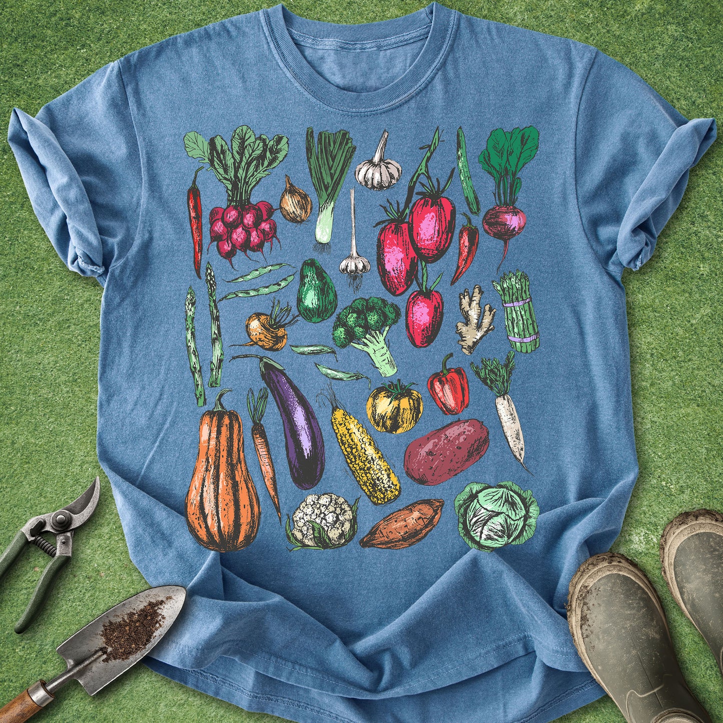 Blue t-shirt with colorful vegetable illustrations on a green background