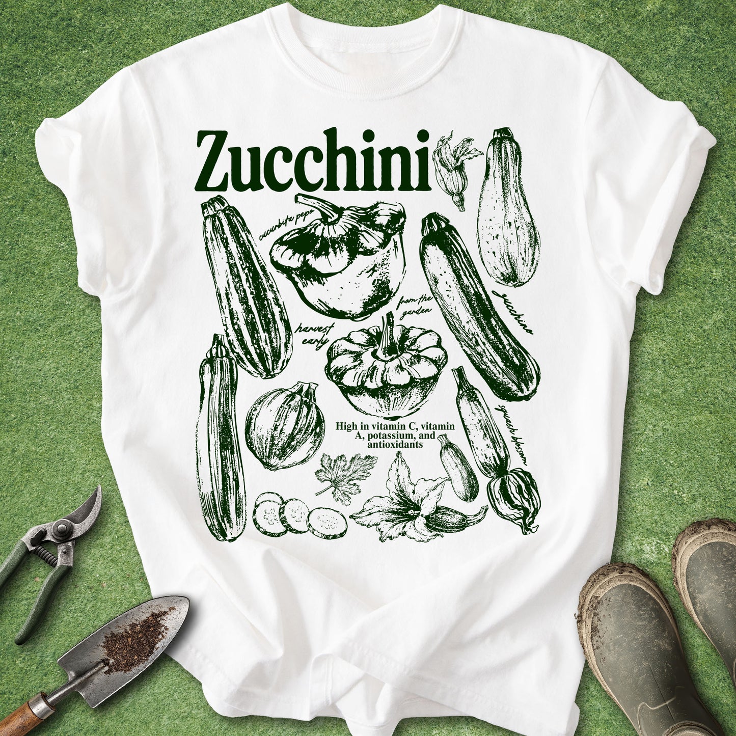 White t-shirt with zucchini graphic design on a green background