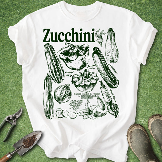 White t-shirt with zucchini graphic design on a green background
