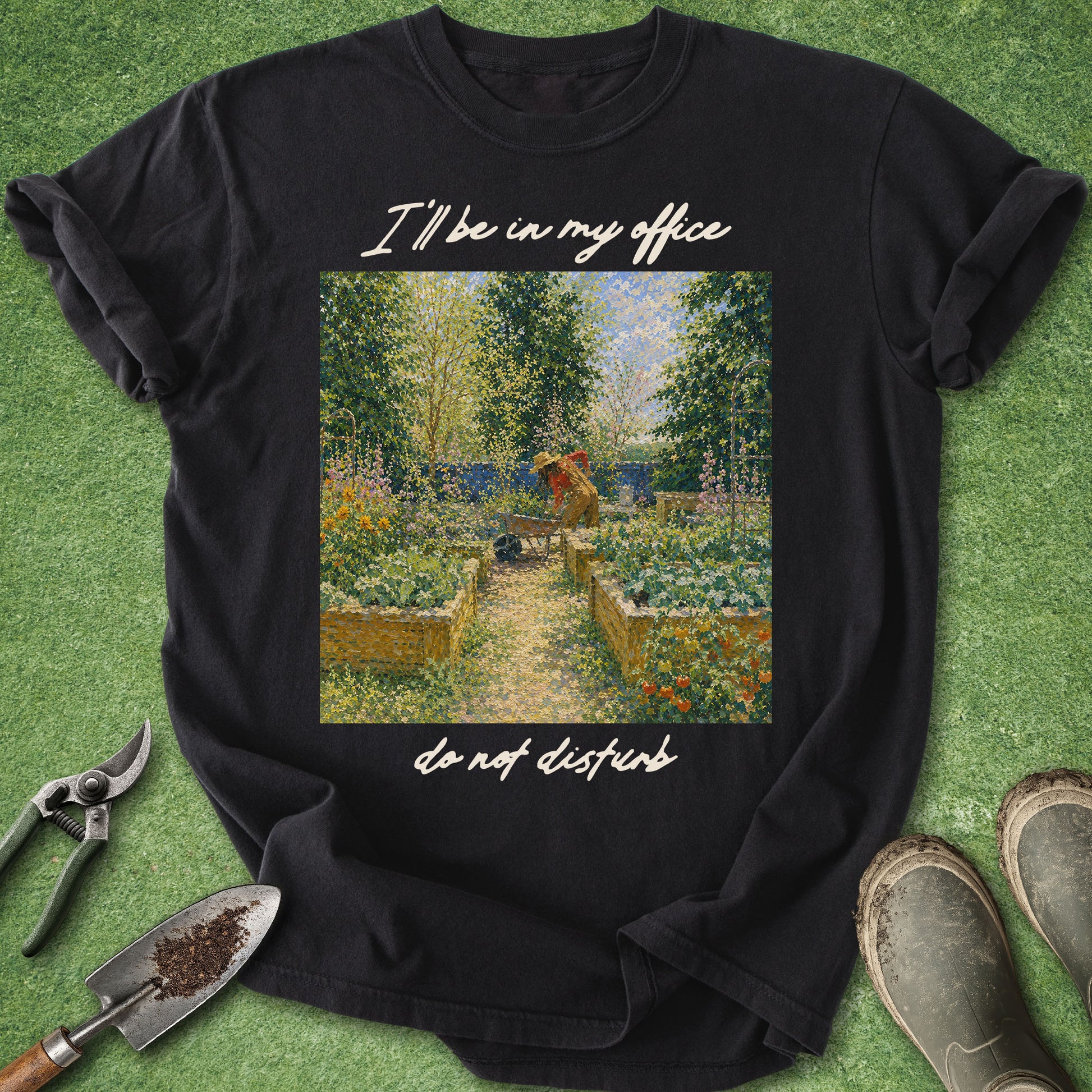 Black t-shirt with garden graphic and text on a grass background