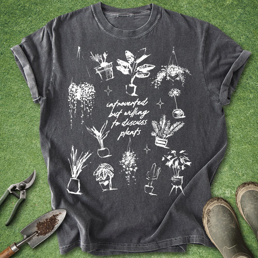 Comfort Colors pepper t-shirt featuring hand-drawn houseplants surrounding the phrase "Introverted but Willing to Discuss Plants" in a minimalist white botanical design.