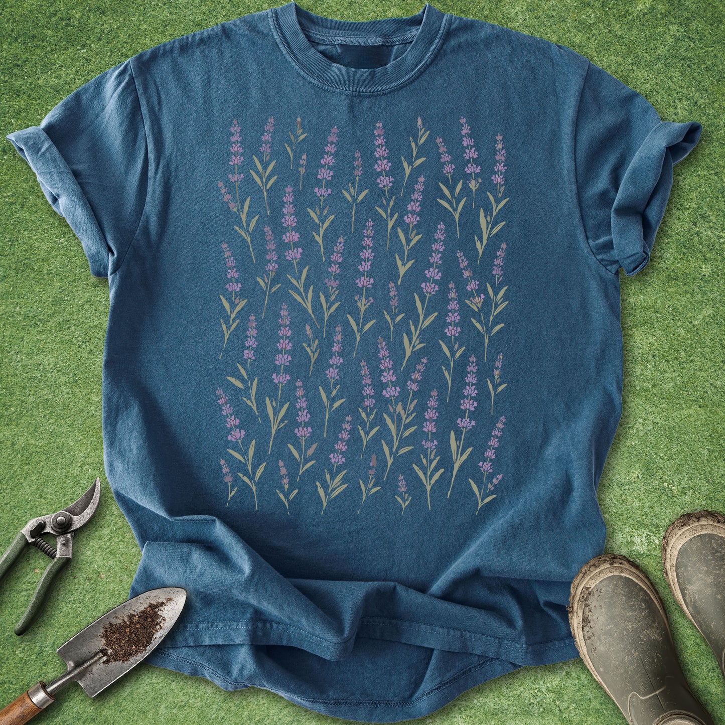 Blue t-shirt with floral design on a green grass background