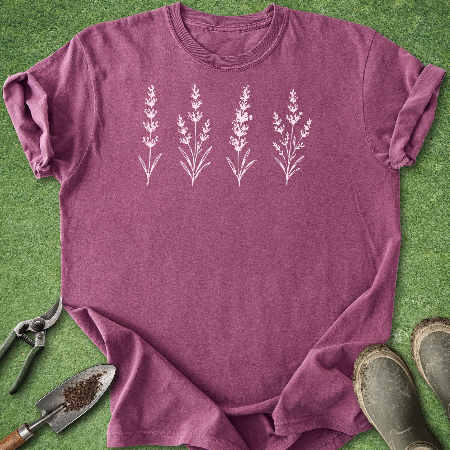Purple t-shirt with floral design on a green background