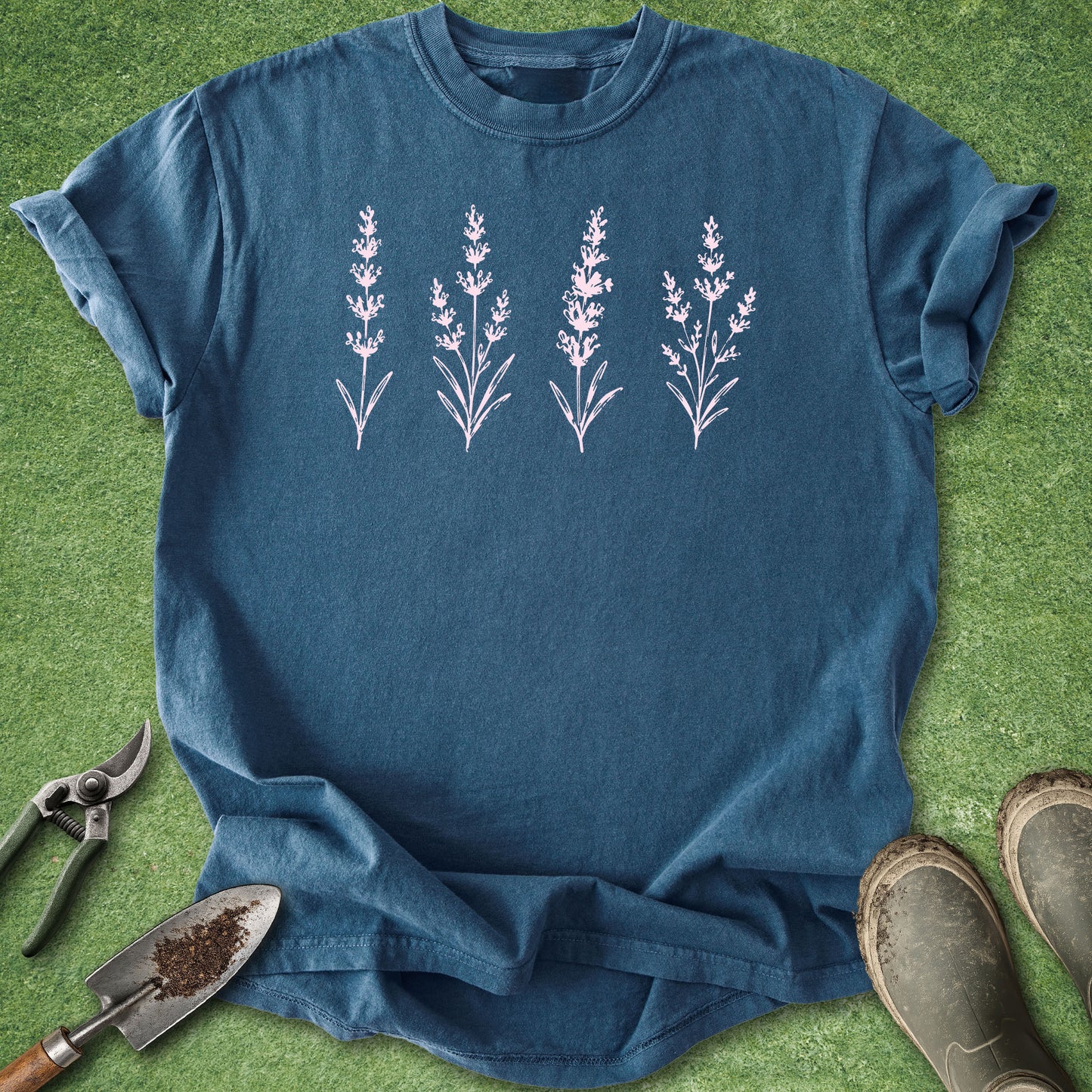 Blue t-shirt with lavender plant design on a green grass background