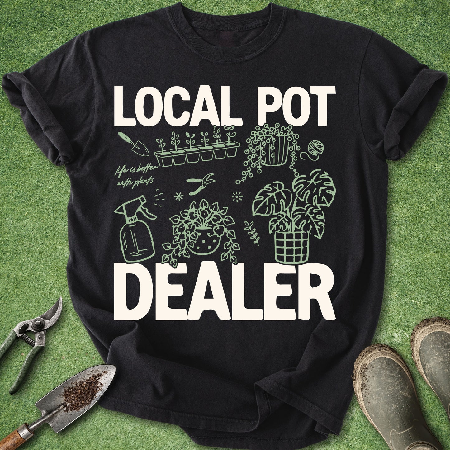 Black Comfort Colors t-shirt featuring the phrase "Local Pot Dealer" with illustrated houseplants, propagation tray, watering spray bottle, pruning shears, hanging plant, monstera, and indoor gardening accessories.