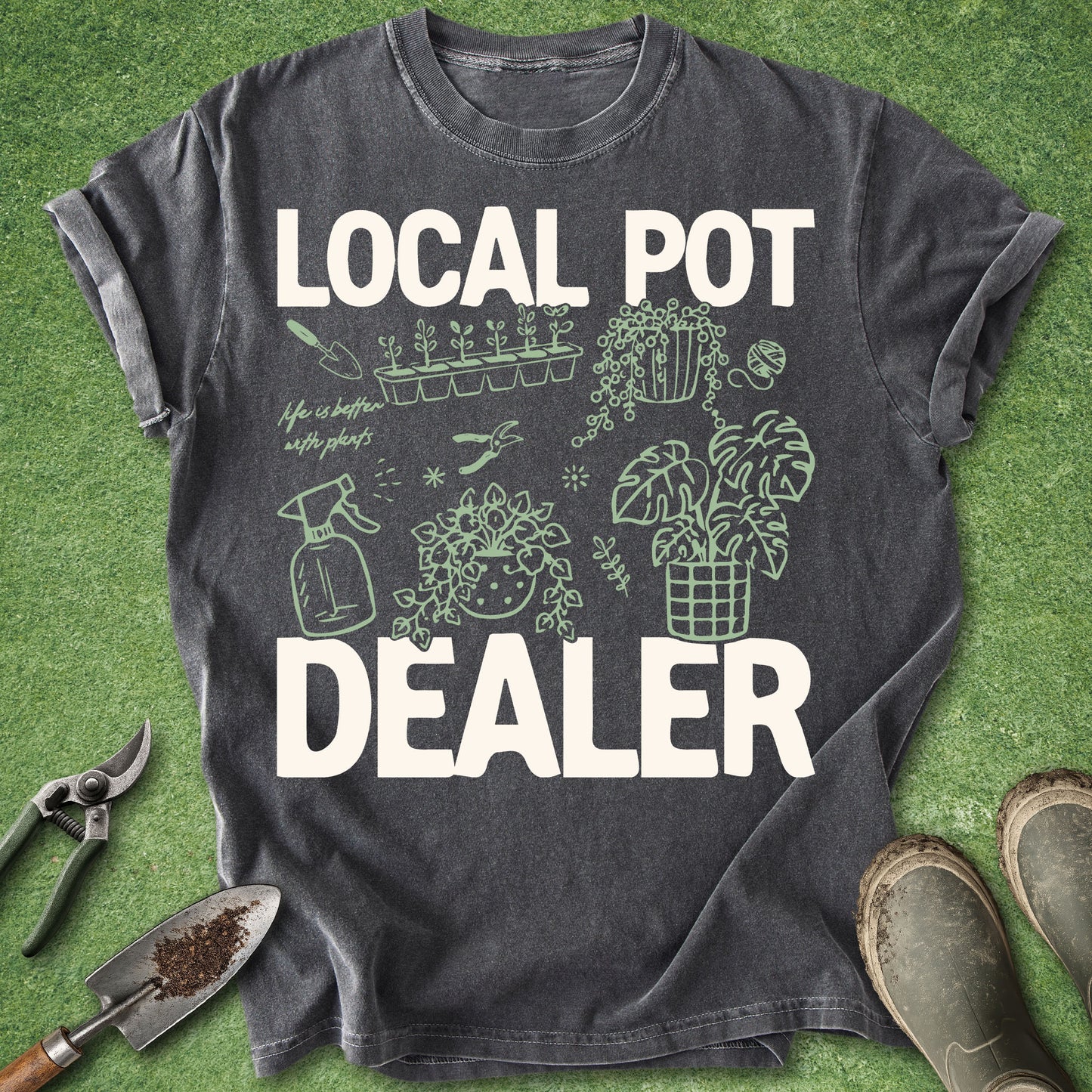 Pepper Comfort Colors t-shirt featuring the phrase "Local Pot Dealer" with illustrated houseplants, propagation tray, watering spray bottle, pruning shears, hanging plant, monstera, and indoor gardening accessories.