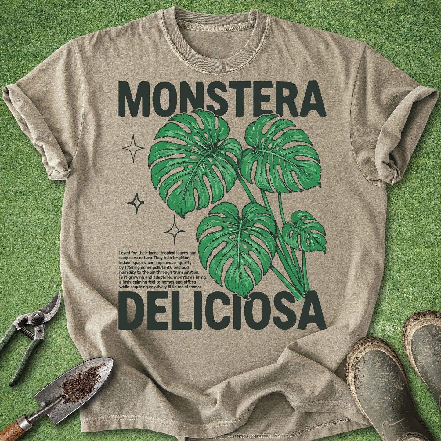 Beige t-shirt with green monstera deliciosa leaves and text on a green background