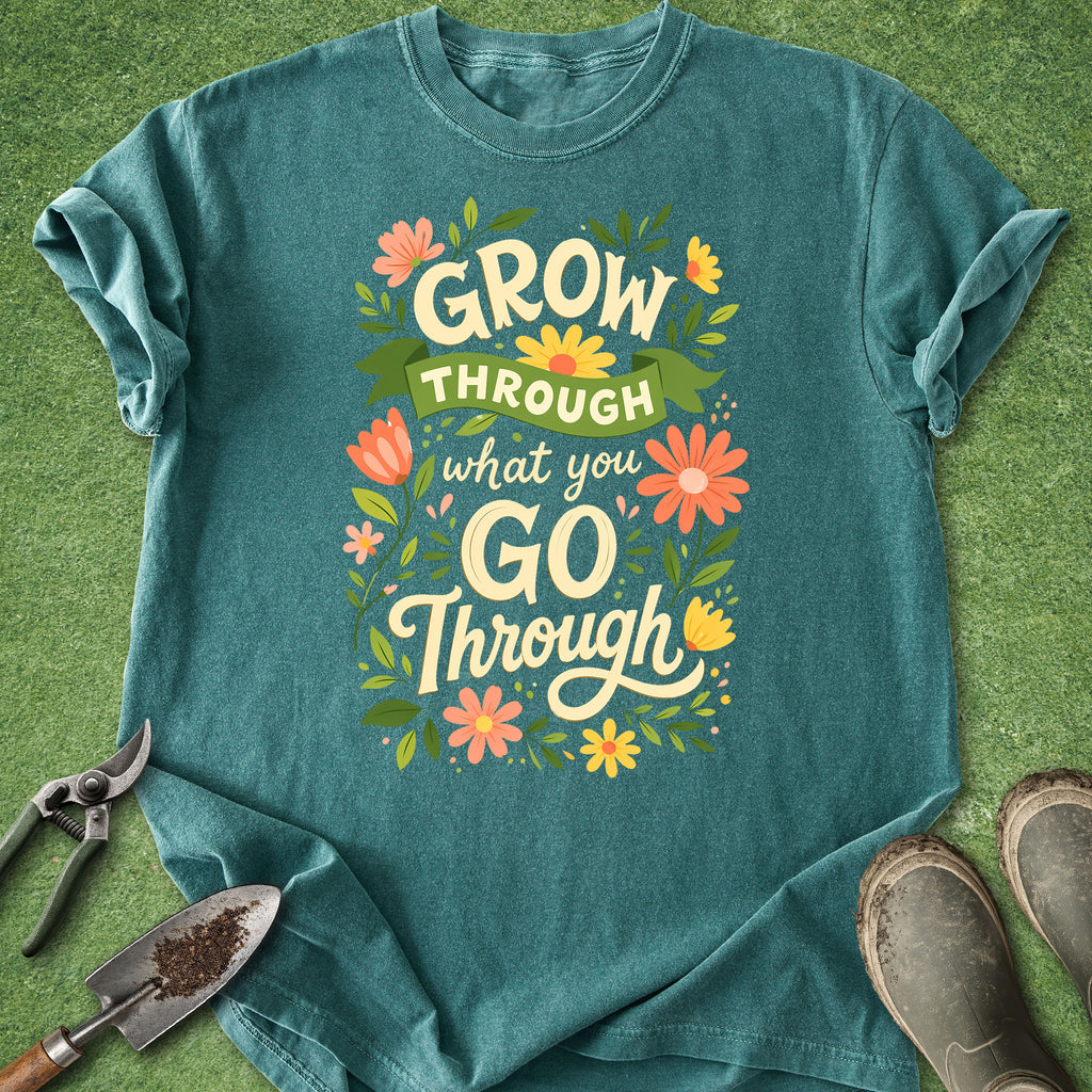 Teal t-shirt with motivational quote and flowers on a grass background