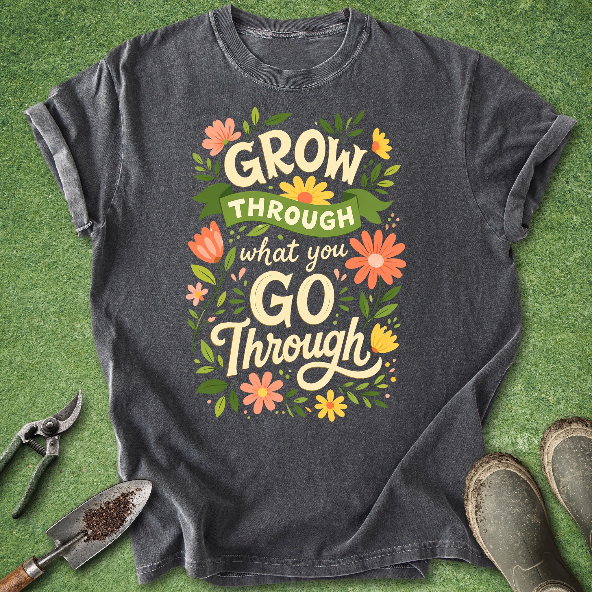 Dark gray t-shirt with motivational quote on a green grass background