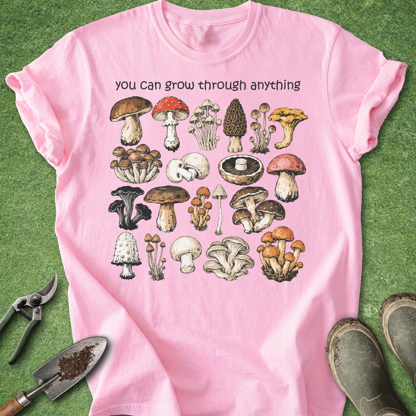 Pink t-shirt with mushroom illustrations and text on a green background