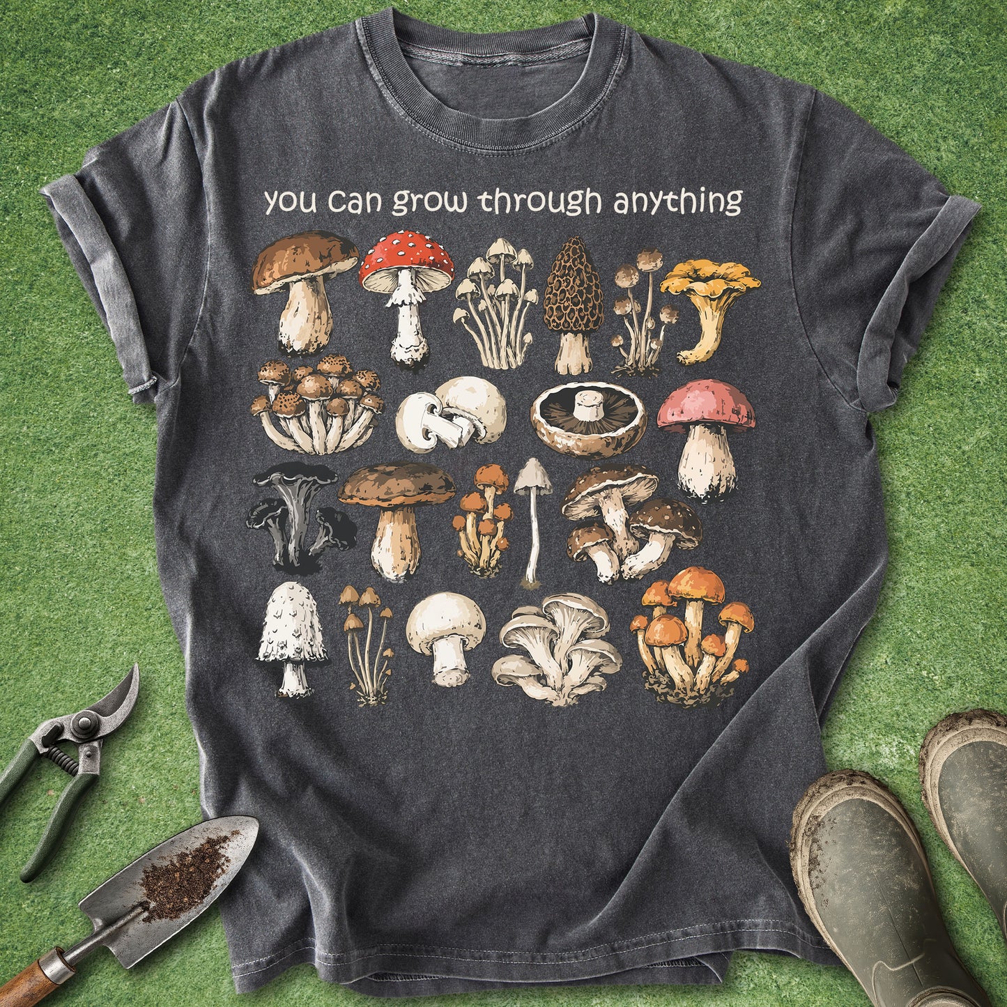 Pepper Comfort Colors t-shirt featuring the phrase "You Can Grow Through Anything" above a vintage botanical collection of colorful wild mushroom illustrations in a woodland field guide style.