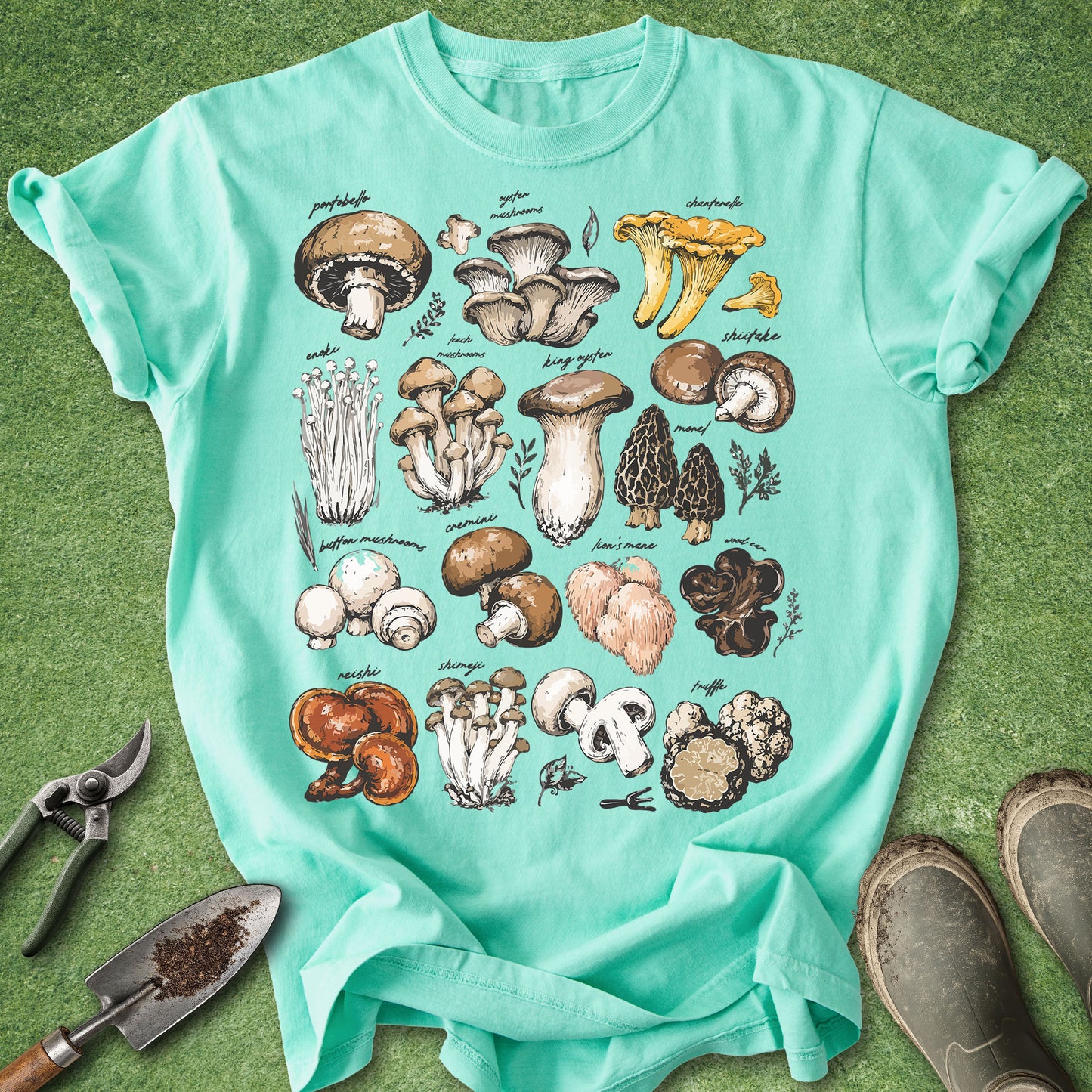 Teal t-shirt with mushroom illustrations on a green background