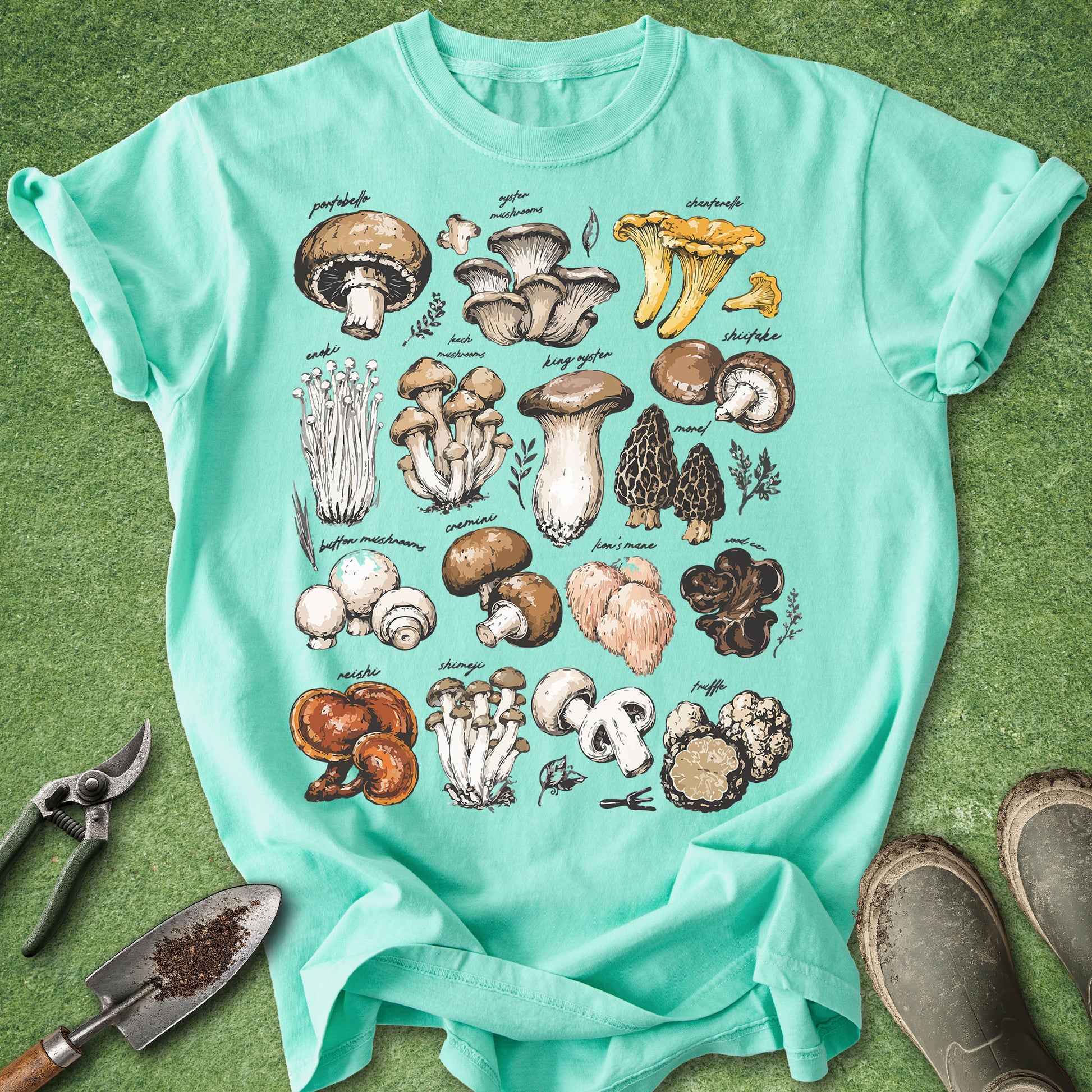 Teal t-shirt with mushroom illustrations on a green background