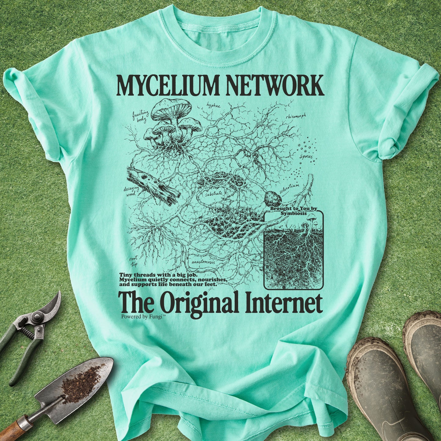 Mint green t-shirt with 'Mycelium Network' graphic on a grass background