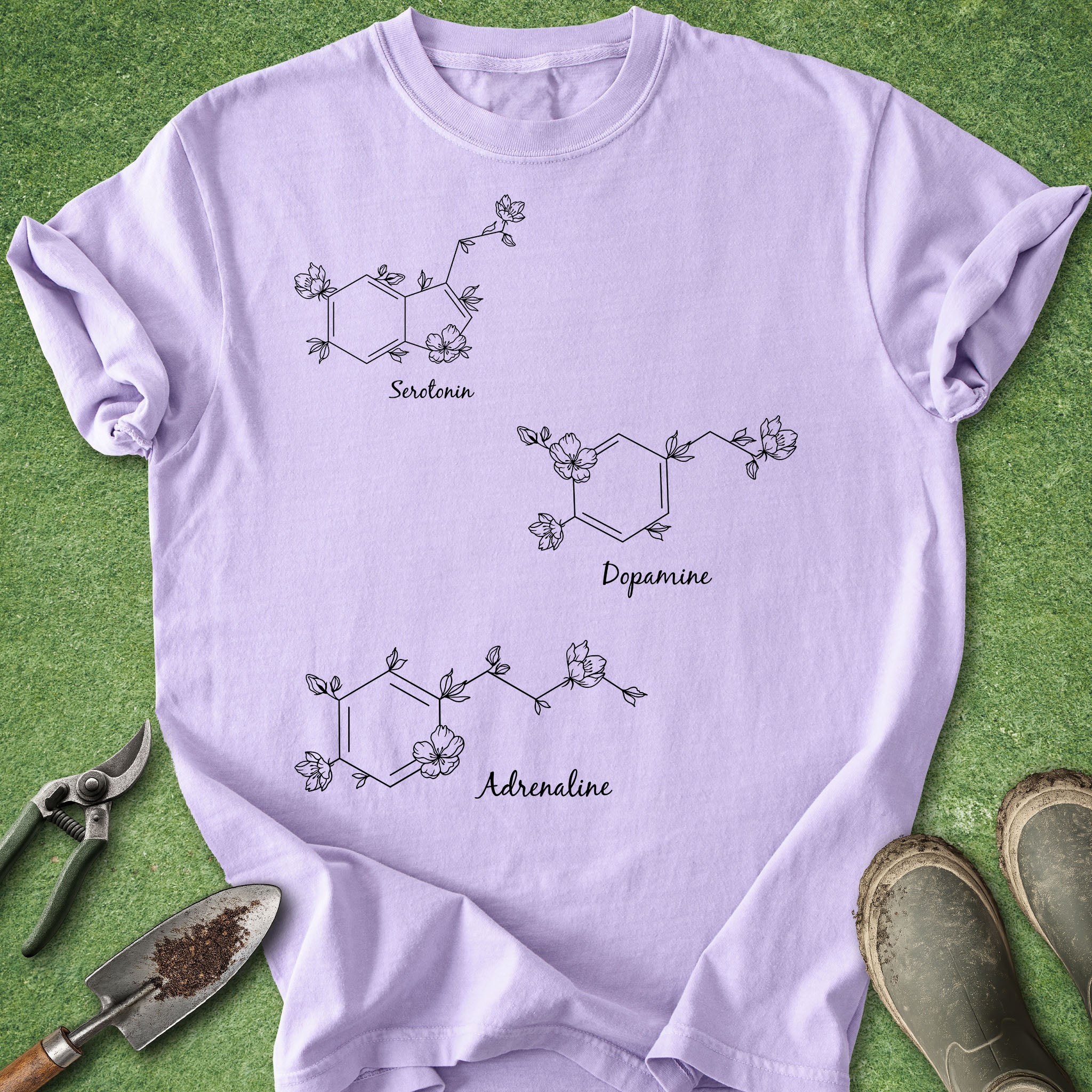 Purple t-shirt with chemical structure diagrams on a green grass background