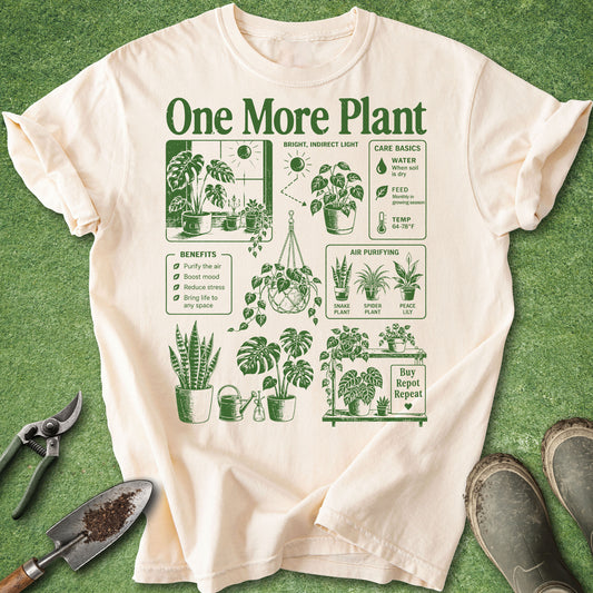 Ivory t-shirt with “One More Plant” text and green vintage-style houseplant illustrations featuring monstera, snake plant, hanging plants and plant care graphics.