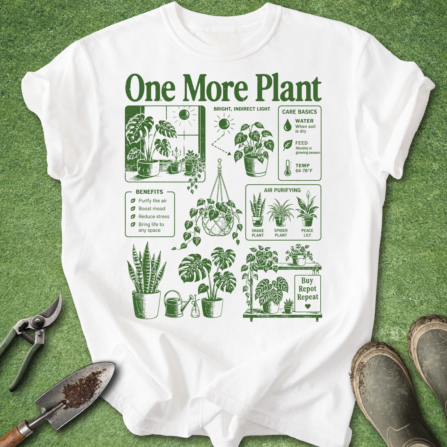 A white short-sleeve T-shirt laid flat on a green textured surface, printed with dark green plant care illustrations and the text 'One More Plant.' Gardening props including pruning shears, a trowel, and boots are placed around it.