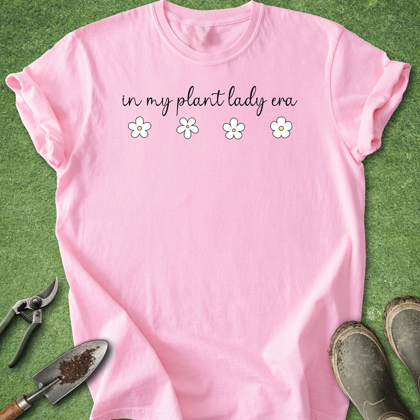 Pink t-shirt with 'in my plant lady era' text on a grass background