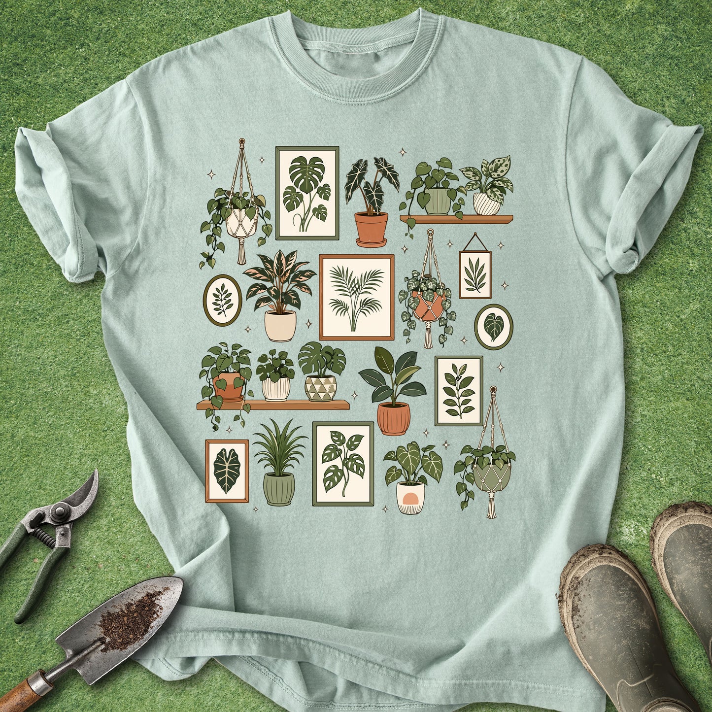 Light green t-shirt featuring a botanical gallery of houseplants, hanging planters, potted tropical plants, shelves and framed plant artwork.