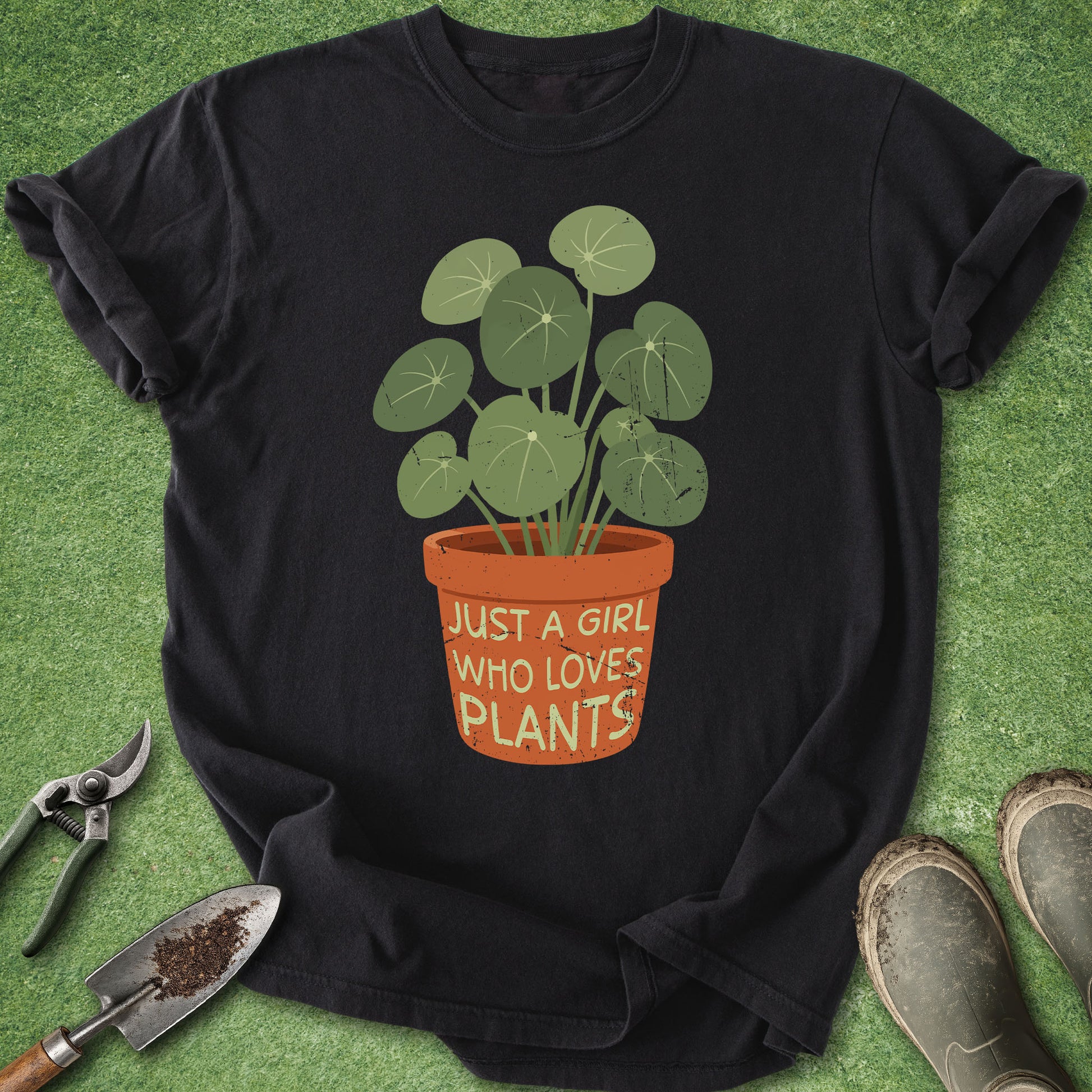 Comfort Colors Black t-shirt featuring a potted houseplant with the phrase "Just a Girl Who Loves Plants" printed on the flower pot.