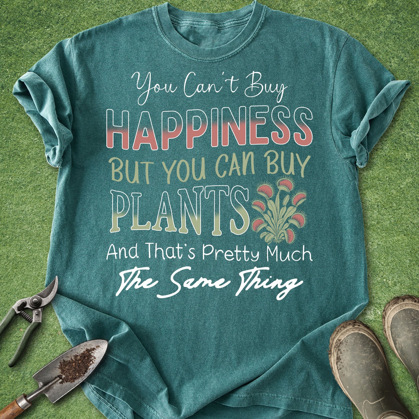Teal t-shirt with gardening-themed text on a grass background