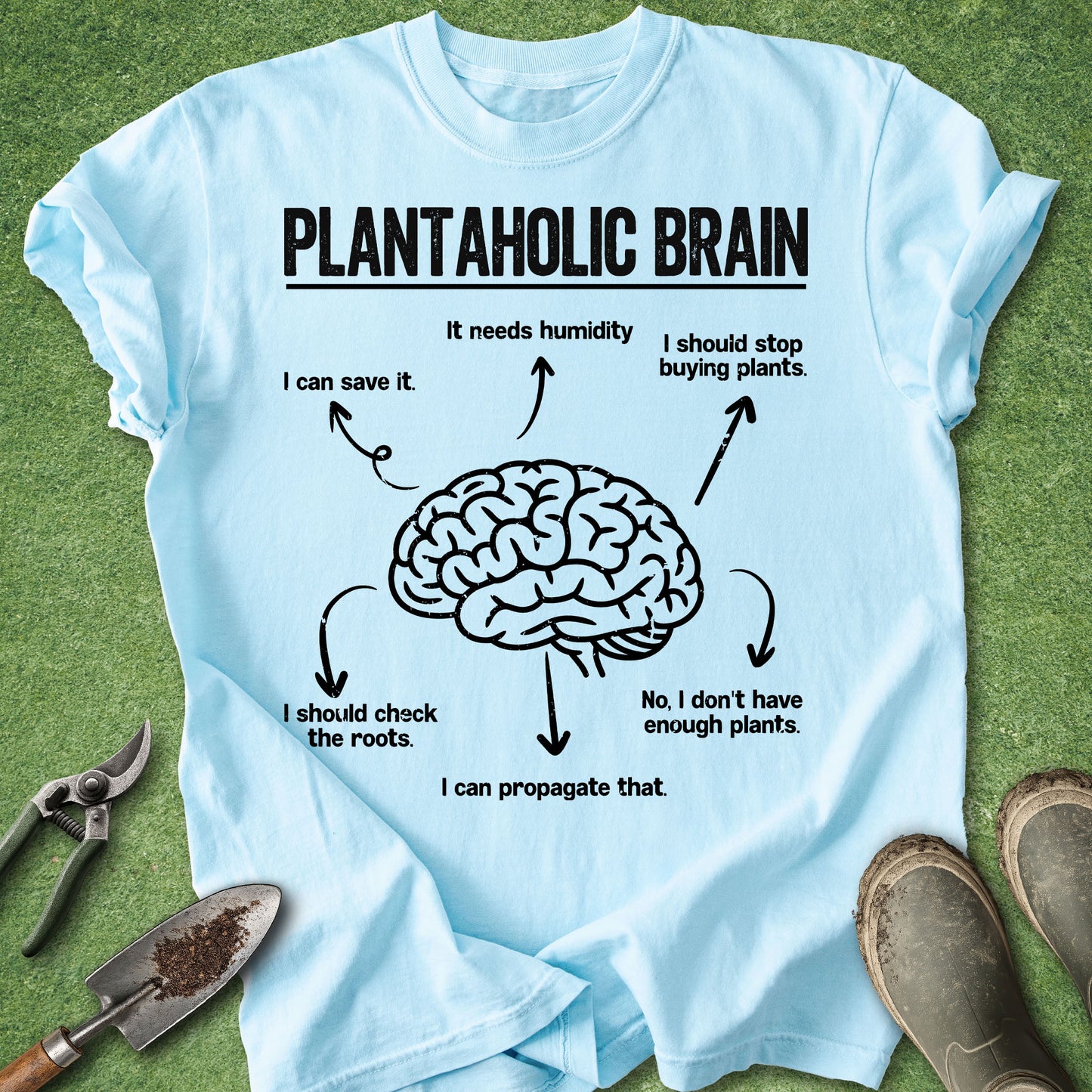 Light blue t-shirt with a brain graphic and text on a grass background