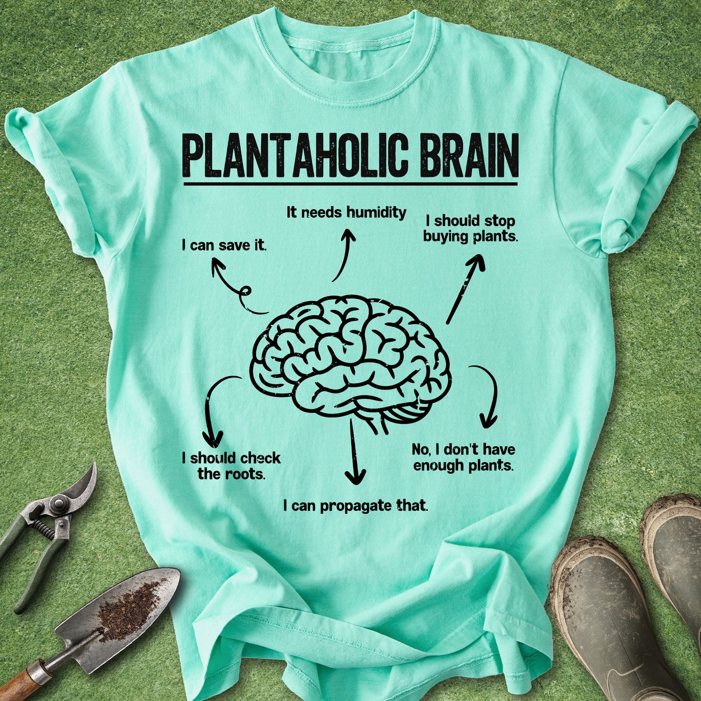 Light blue t-shirt with a brain graphic and text on a green grass background