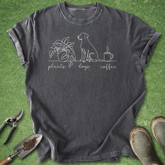 Minimalist line art shirt featuring a potted houseplant, a sitting dog, and a steaming coffee mug with the words "plants dogs coffee."