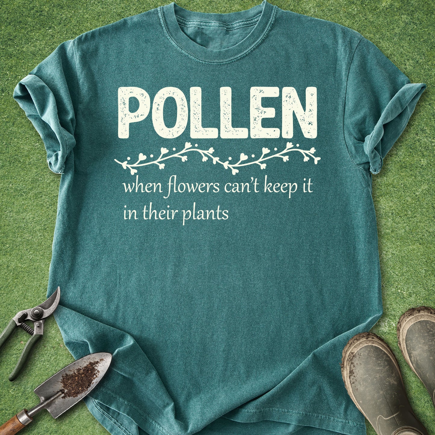 Teal t-shirt with 'Pollen' text on a grass background
