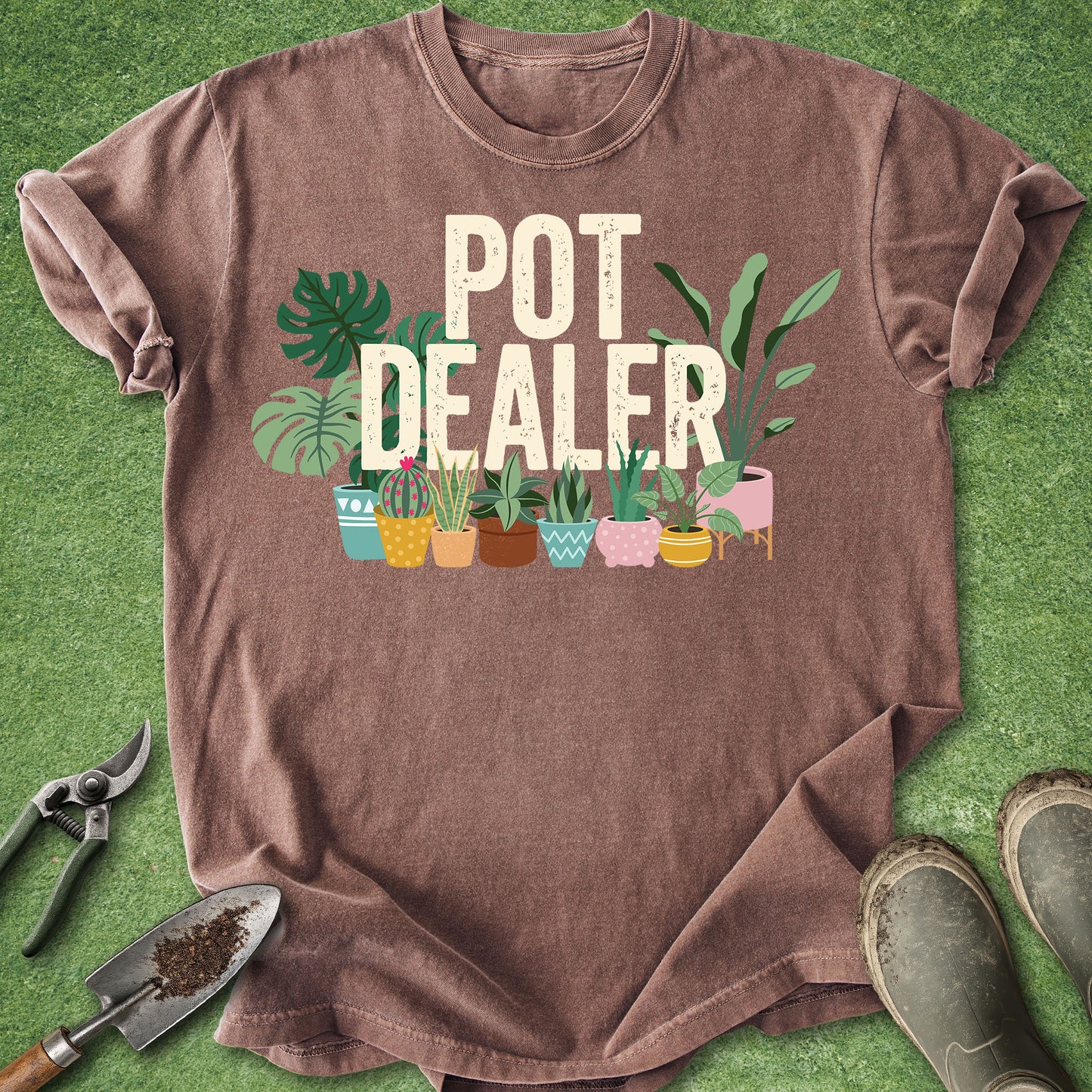Espresso Comfort Colors t-shirt featuring the phrase "Pot Dealer" above colorful illustrated potted houseplants including monstera, snake plants, cactus, and tropical foliage in decorative planters.