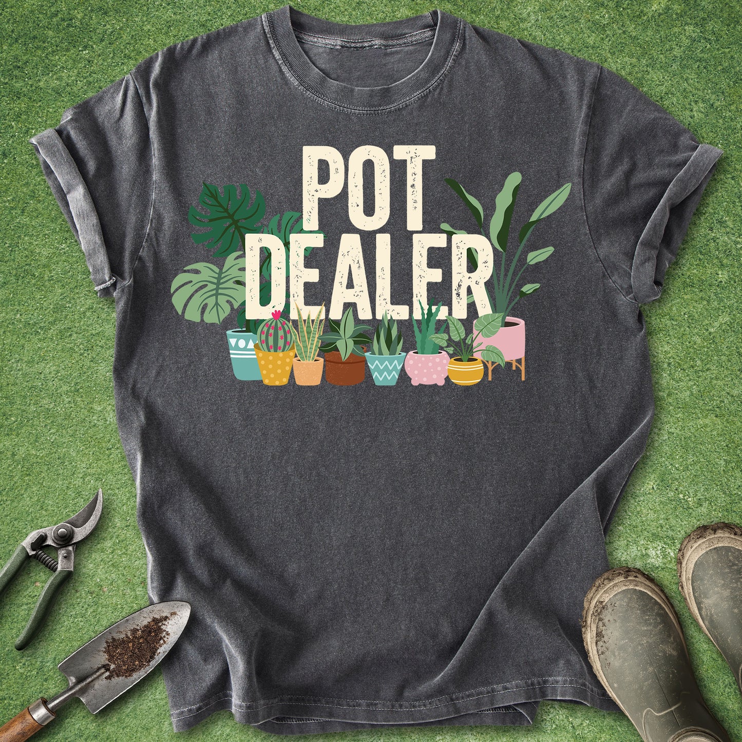 Pepper Comfort Colors t-shirt featuring the phrase "Pot Dealer" above colorful illustrated potted houseplants including monstera, snake plants, cactus, and tropical foliage in decorative planters.