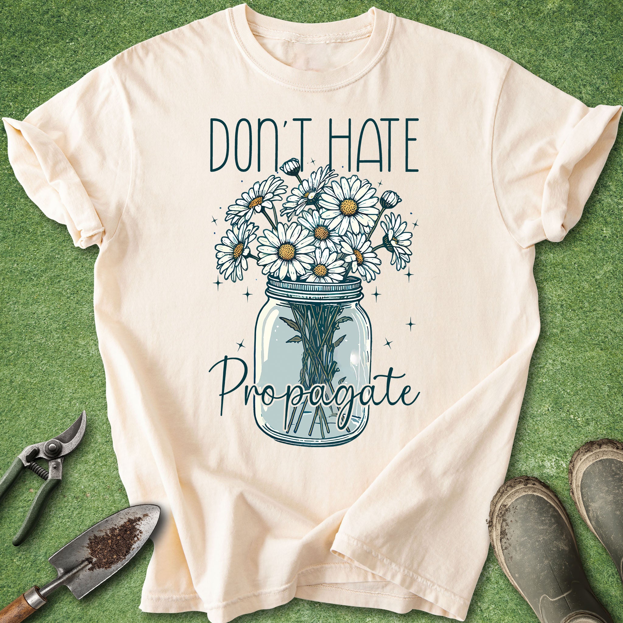 Cream t-shirt with “Don’t Hate Propagate” text and daisy mason jar illustration