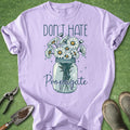 Purple t-shirt with a graphic of flowers in a jar and text 'Don't Hate Propagate' on a green background.