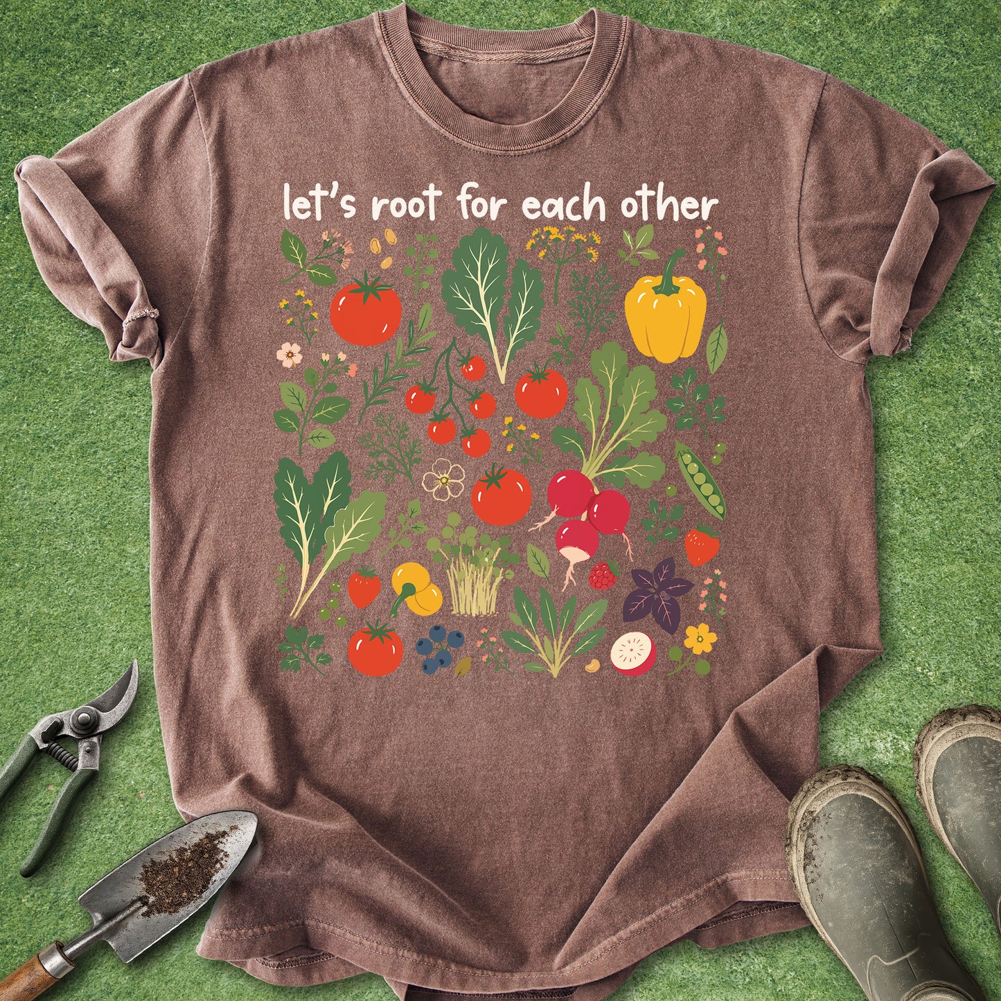 Brown t-shirt with vegetable graphic and text 'let's root for each other' on a green background