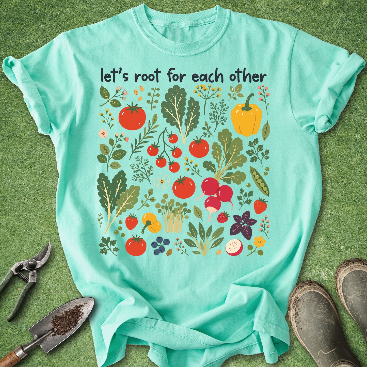 Teal t-shirt with vegetable graphic and text 'let's root for each other' on a green background