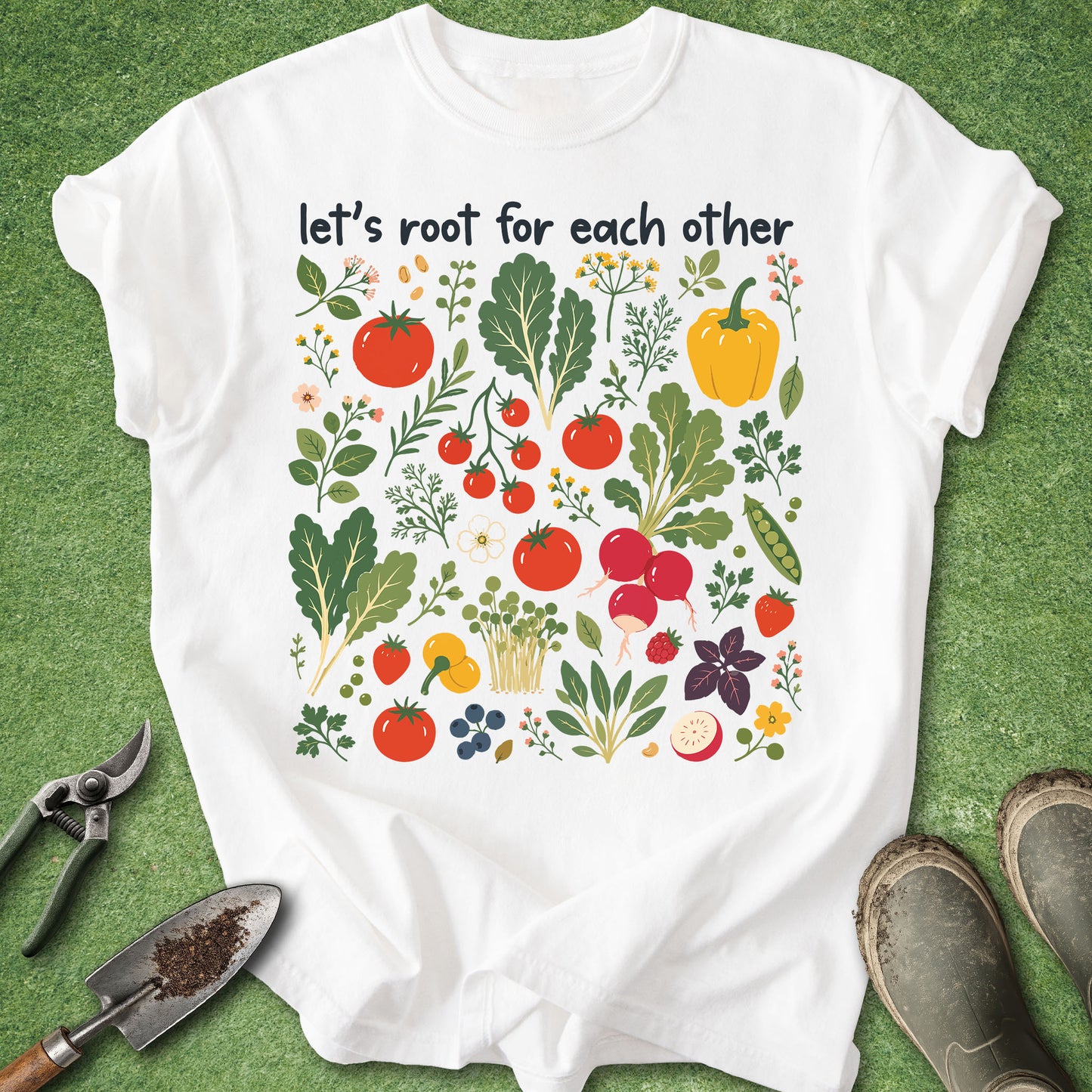 White t-shirt with vegetable design and text 'let's root for each other' on a green background