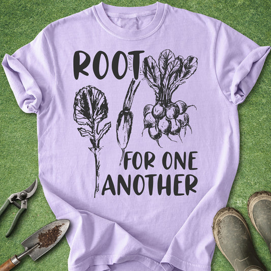Comfort Colors orchid t-shirt featuring the phrase "Root for One Another" with vintage-style illustrations of leafy root vegetables including radishes and beets in black ink.