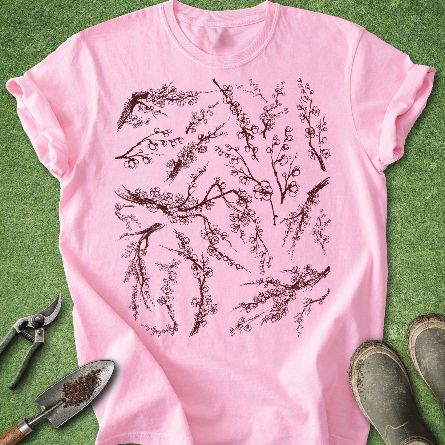 Pink t-shirt with cherry blossom design on a green background