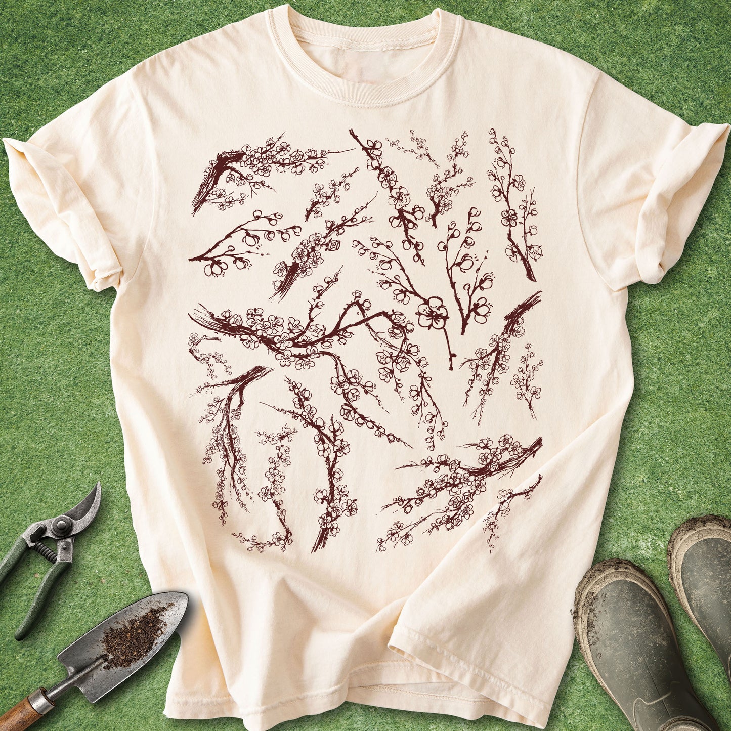 Ivory Comfort Colors t-shirt featuring an intricate collection of vintage-style cherry blossom branches with delicate sakura flowers arranged across the front of the shirt.