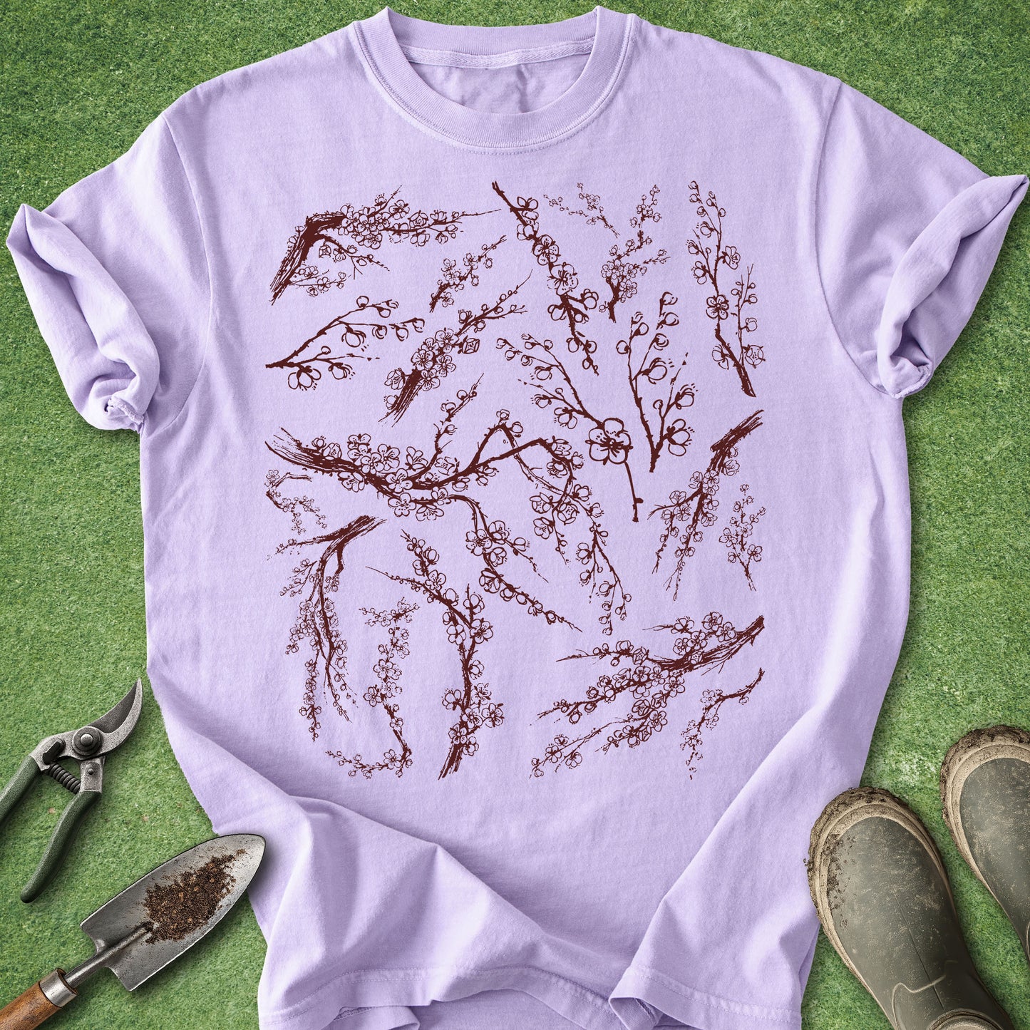 Light purple t-shirt with floral design on a green background