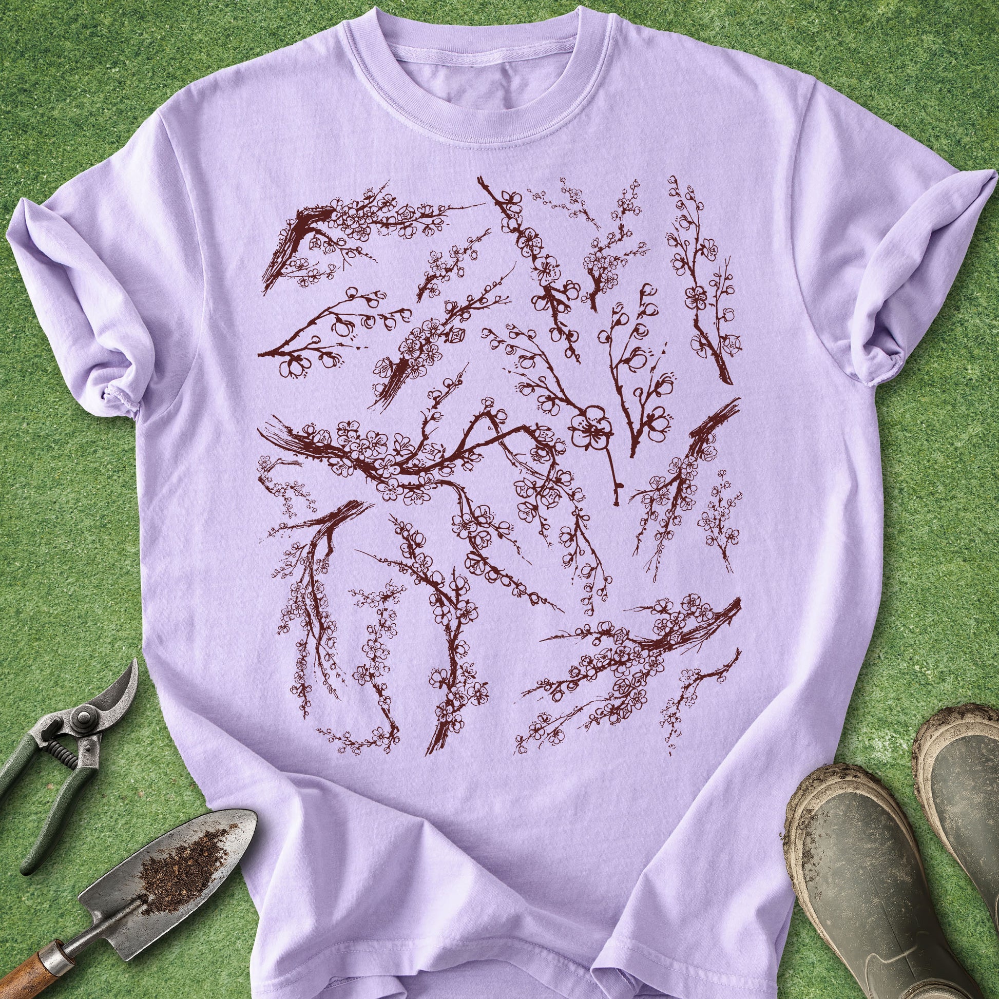 Light purple t-shirt with floral design on a green background