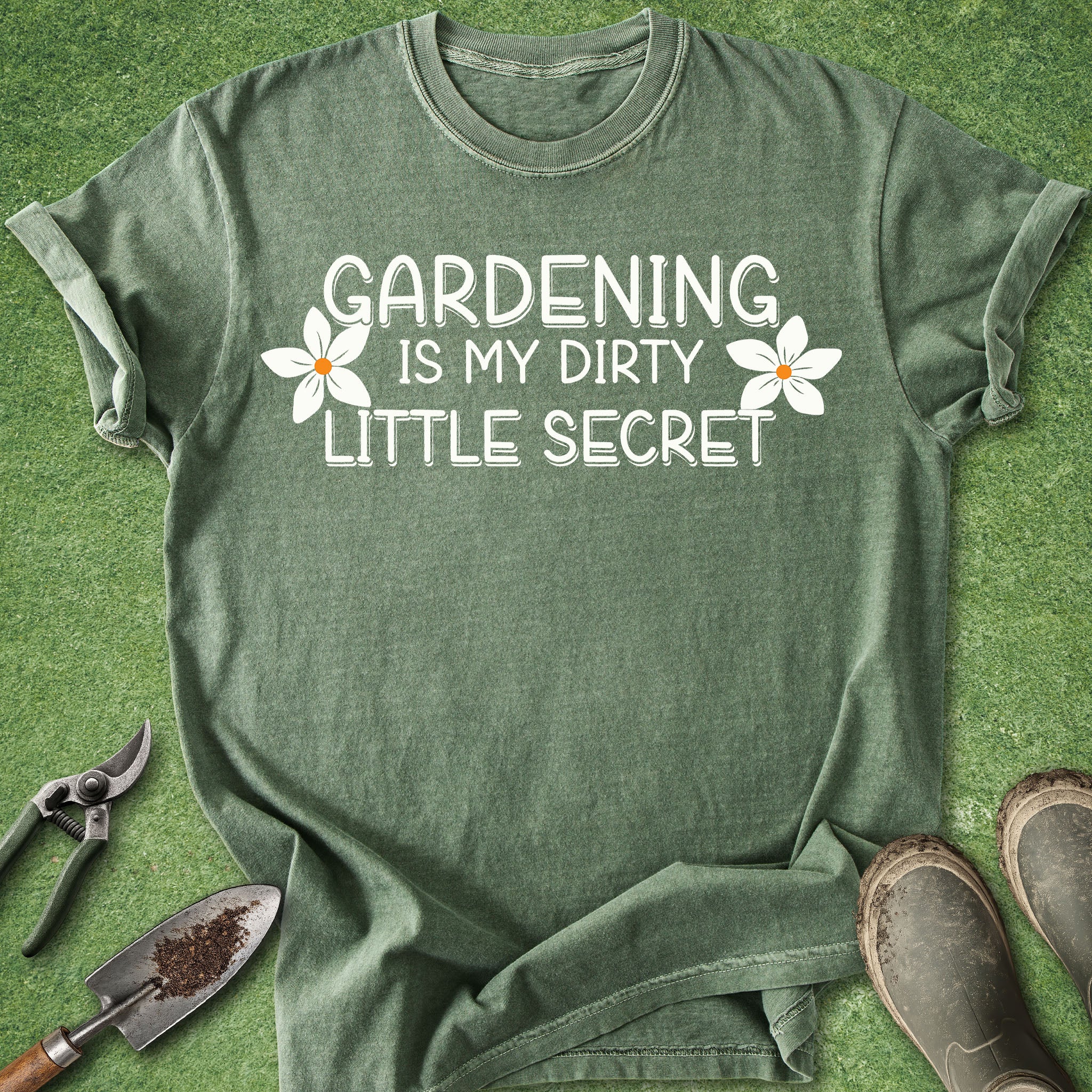Green t-shirt with 'Gardening is my dirty little secret' text on a grass background